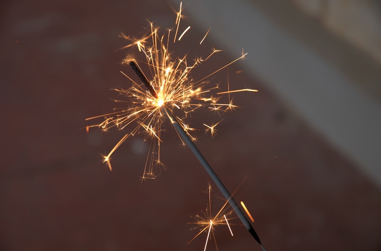 A closeup of a sparkler burning