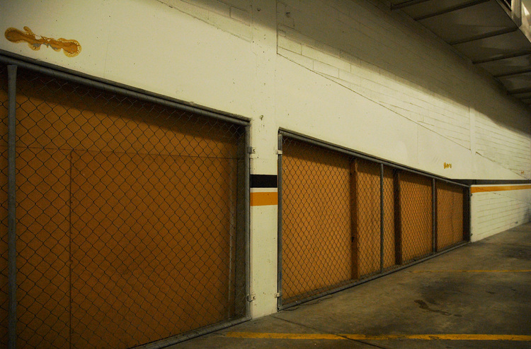A wall and mesh fence in a car-park