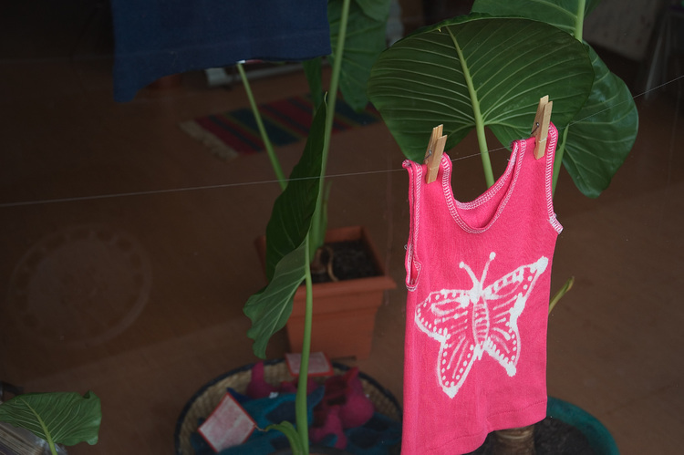 A pink singlet hanging in a shop window