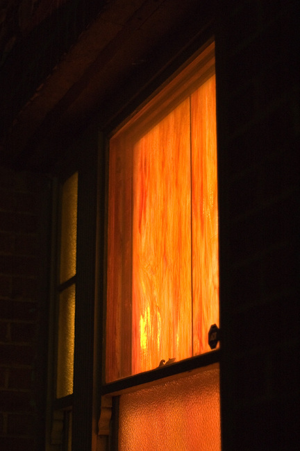 A glowing, orange-painted window at night