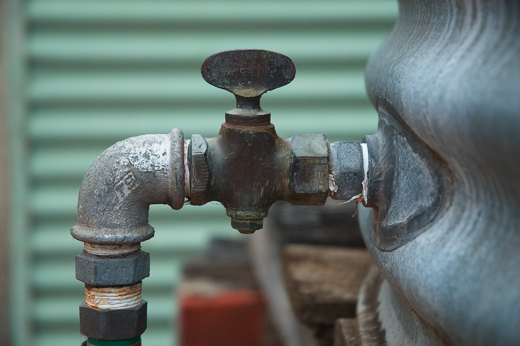 The tap on the side of a rainwater tank