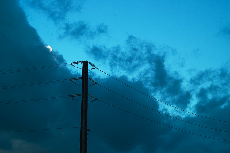 Power lines against an early evening sky