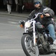A guy on a motorcycle, in the city