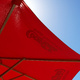 A red umbrella against a blue sky