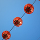 Red paper lanterns against a blue sky