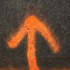 An orange spray-painted arrow