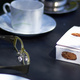 Reading glasses, coffee cups, and a chocolate box