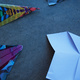 An array of paper planes, lying on the ground