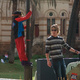 Michael hanging from a pole, chating to a guy on a Segway